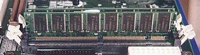 Módulo de memoria PC100 en formato DIMM, a medio introducir en su zócalo